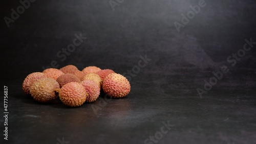 Lychee fruits isolated against dark background