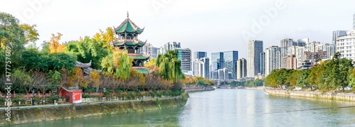 Panorama of Wangjiang Pavilion during Autumn in Chengdu, Sichuan, China, overlooking the Jinjiang River with residential and corporate office buildings in the background photo