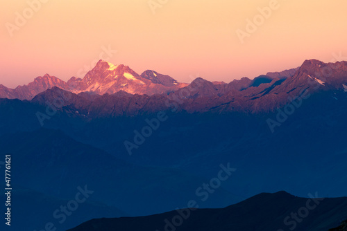 First morning light hits the top of Hochgall  Monte Collalto  in Italian Alps. Early morning view from Glorerhutte in High Tauern  Austria. Epic dawn in the mountains.
