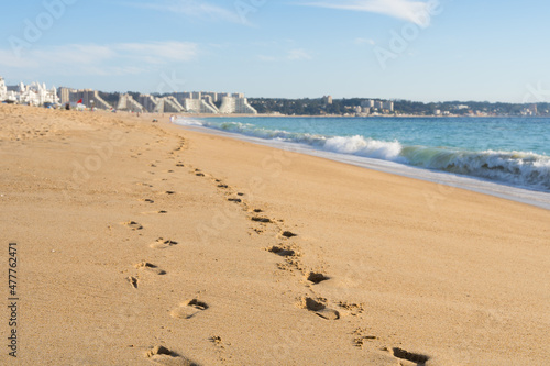 Closeup of footprints on sand by the sea with blurred background on sunny day in Algarrobo beach  Chile