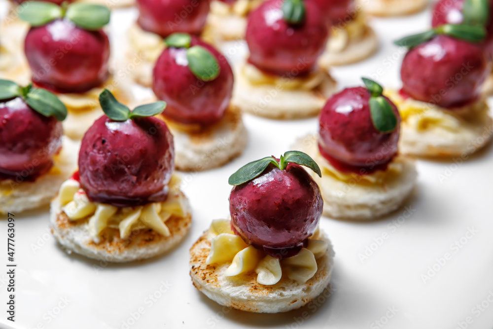 Duck liver rolled into a beetroot ball with buttercream and decorated with herbs. Duck liver rolled into a beetroot ball with buttercream and decorated with herbs.