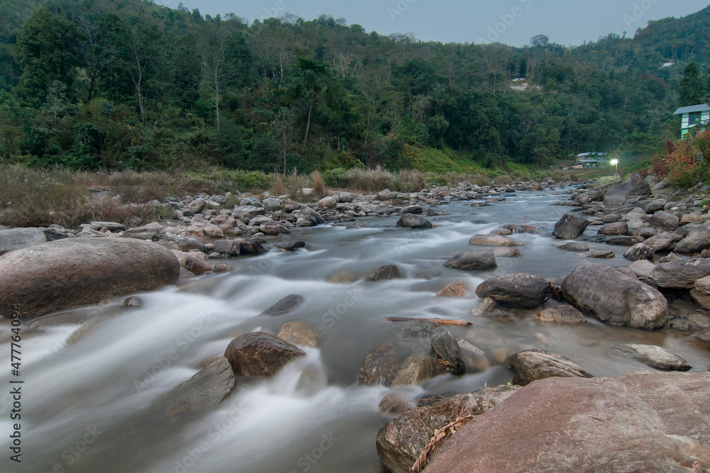 Beautiful Reshi River water flowing through stones and rocks at dawn, Sikkim, India. Reshi is one of the most famous rivers of Sikkim flowing through the state and serving water to many local people. Beautiful Reshi River water flowing through stones and rocks at dawn, Sikkim, India. Reshi is one of the most famous rivers of Sikkim flowing through the state and serving water to many local people.