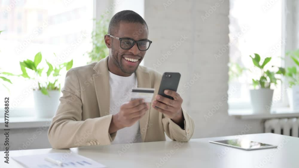 African Man making Successful Online Payment on Smartphone African Man making Successful Online Payment on Smartphone