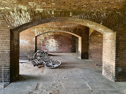 Cannon artillery cart in Fort Jefferson at Dry Tortugas National Park, Florida Keys. Gunrooms known as casemates, form a honeycomb of brick masonry arches. photo