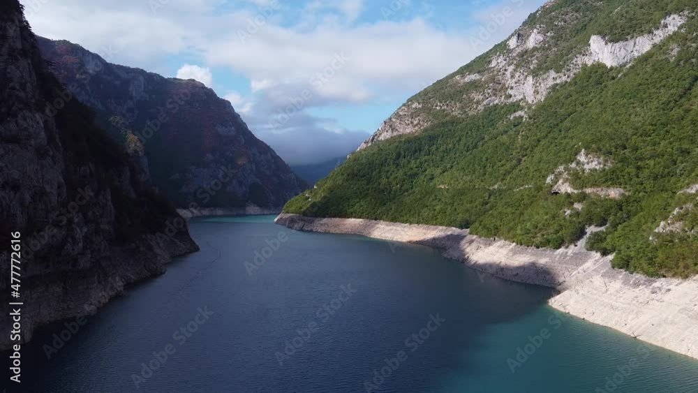 Large water channel between mountain ranges. View from drone. Aerial view of Piva river in Montenegro. Large water channel between mountain ranges. View from drone. Aerial view of Piva river in Montenegro.