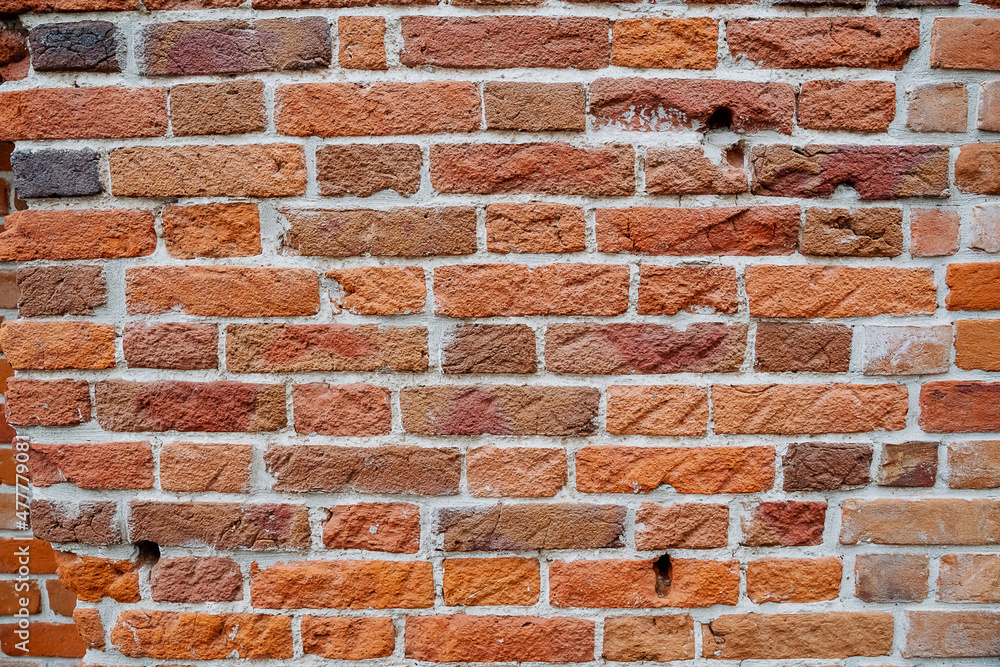 Obraz premium A close-up of the brick wall. The masonry of the wall is made of red brick. The texture of the old house.