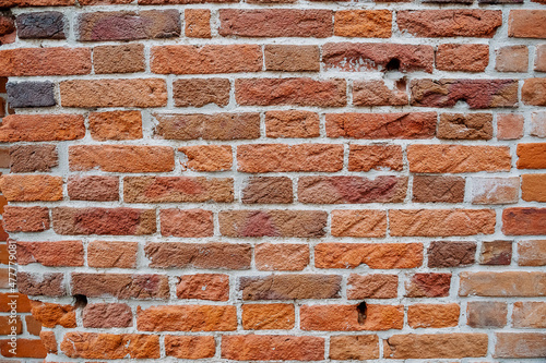 A close-up of the brick wall. The masonry of the wall is made of red brick. The texture of the old house.