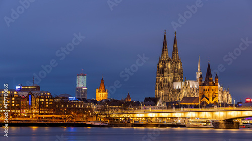 Illuminated historical buildings against Cologne winter skyline