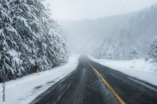 Snowy and frozen mountain road in winter landscape