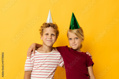 Boy and girl smiling and posing in casual clothes against on colored background