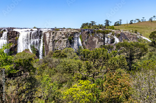 Waterfall with fields and forest around