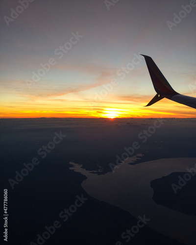 View of sunset from airplane window © Colleen