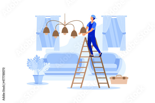 Master Household Works Hangs Chandelier at Home. Worker in Overalls Re-establishes Connection Wiring to Lighting Guest Room. He Happily Performs Freedom Work in Cozy and Comfortable Living Room.
