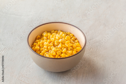 Canned sweet corn in  bowl.