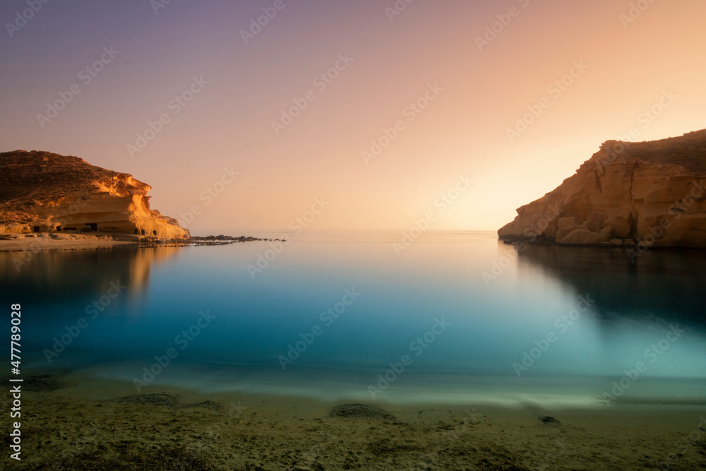 
Sunset on the beach of Cocedores between the Region of Murcia and Andalusia, in Spain. A beach with crystal clear waters and calm greenish blue that invites calm and reflection.