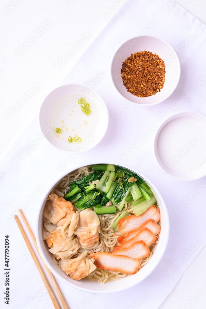 Noodles soup with wonton dumpling and grilled red pork, Asian food, Top view Noodles soup with wonton dumpling and grilled red pork, Asian food, Top view
