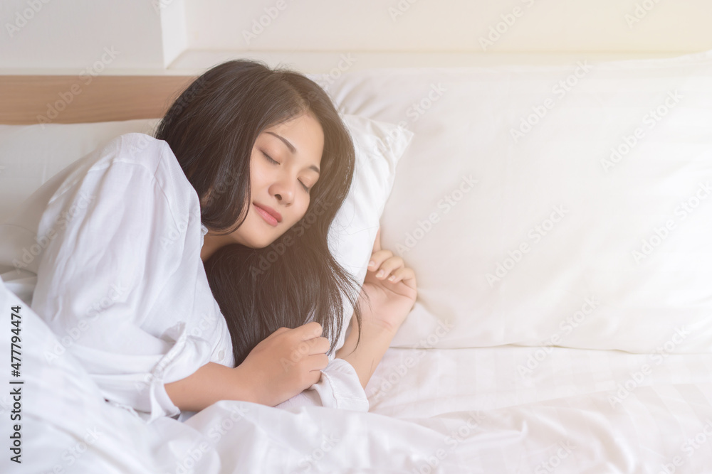 young woman sleeping on bed in bedroom at home young woman sleeping on bed in bedroom at home