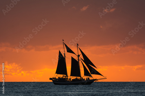 sailboat at sunset photo