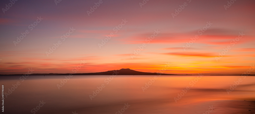 Milford Beach at dawn with Rangitoto Island in the distance, Auckland. Milford Beach at dawn with Rangitoto Island in the distance, Auckland.