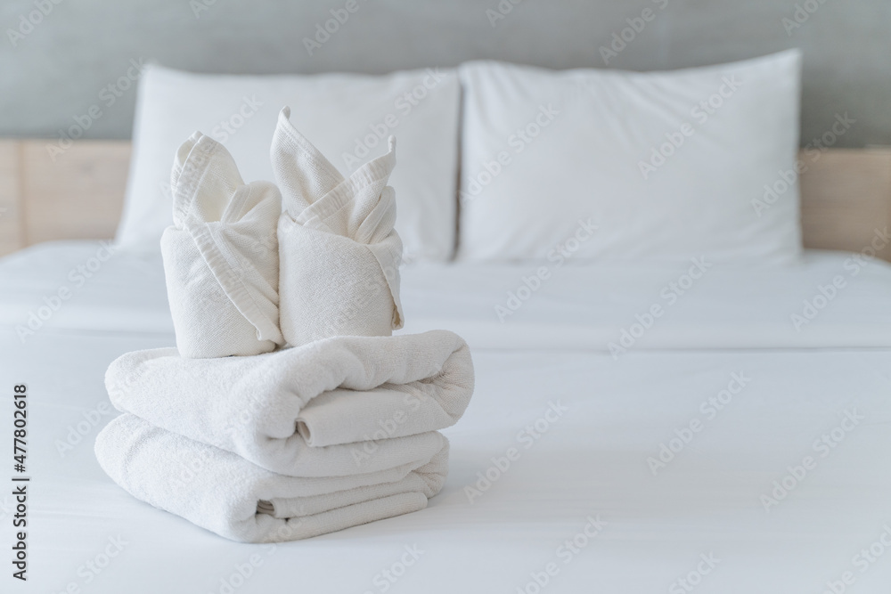 White Fluffy Towels On Bed For Hotel Customer Stock Photo