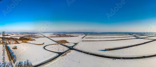 aerial panorama - snow-covered fields near the M4-Don highway in the South of Russia on a sunny winter day
