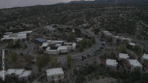 Tilt up from small desert town to cloudy mountains