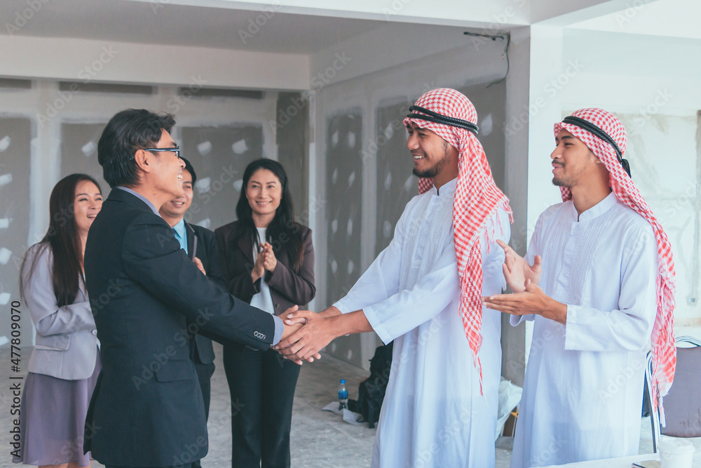 Business team and business partners handshake together to agree joint business and partnership. Business team and business partners handshake together to agree joint business and partnership.