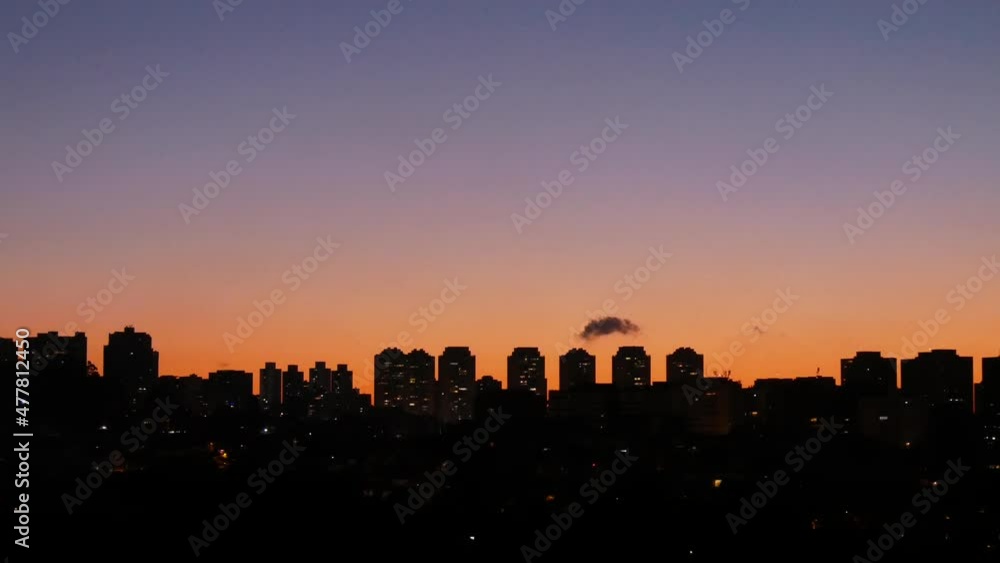 Silhouettes Of A Residential Area With High-Rise Buildings After Sunset With Clear Skies And Small Cloud Silhouettes Of A Residential Area With High-Rise Buildings After Sunset With Clear Skies And Small Cloud