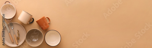 Set of stylish dinnerware on beige background with space for text