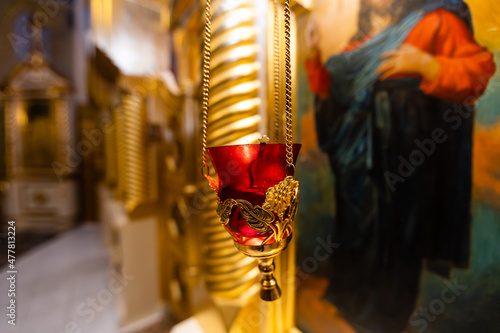 Orthodox christening of a baby, holding gold cross photo