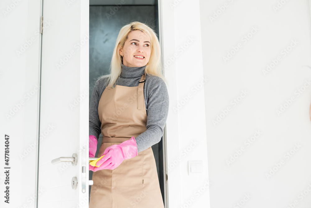 woman doing chores in bathroom at home, cleaning sink and faucet with spray detergent. woman doing chores in bathroom at home, cleaning sink and faucet with spray detergent.
