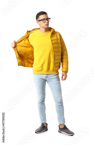 Young man in yellow jacket and sweatshirt on white background