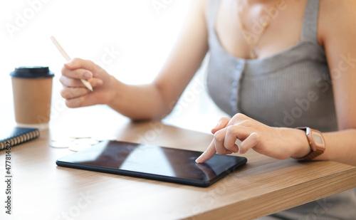 Focus on hand young asian woman in casual colthes using digital laptop working or study online, concept working with new normal and social distancing photo