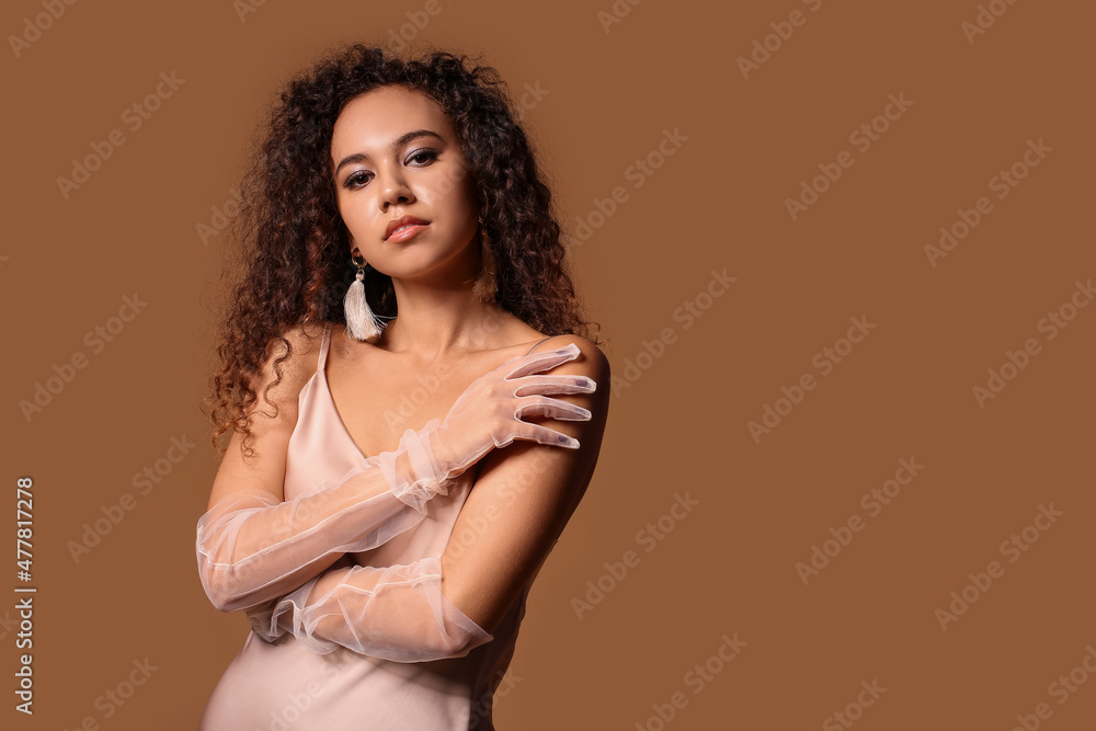 Elegant young woman in evening dress and stylish gloves on color background Elegant young woman in evening dress and stylish gloves on color background