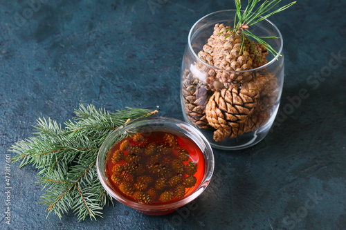 Canvastavla Bowl of tasty pine cone jam and fir tree branch on dark background