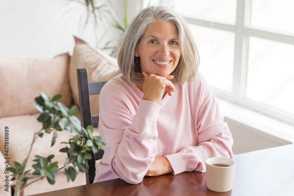 Calm and peaceful middle-aged gray-haired woman takes a break at home Calm and peaceful middle-aged gray-haired woman takes a break at home
