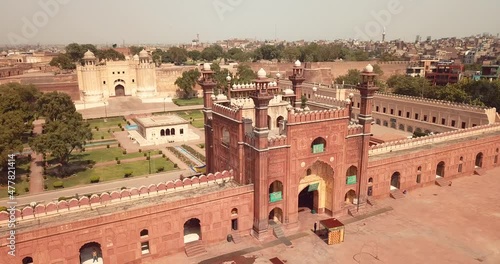 4K Aerial Footage to the Badshahi Mosque main courtyard with the Minarets in carved red sandstone with marble inlay, Pakistan photo
