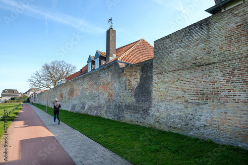 Runner along the city wall of Harderwijk, Gelderland Province, The Netherlands photo
