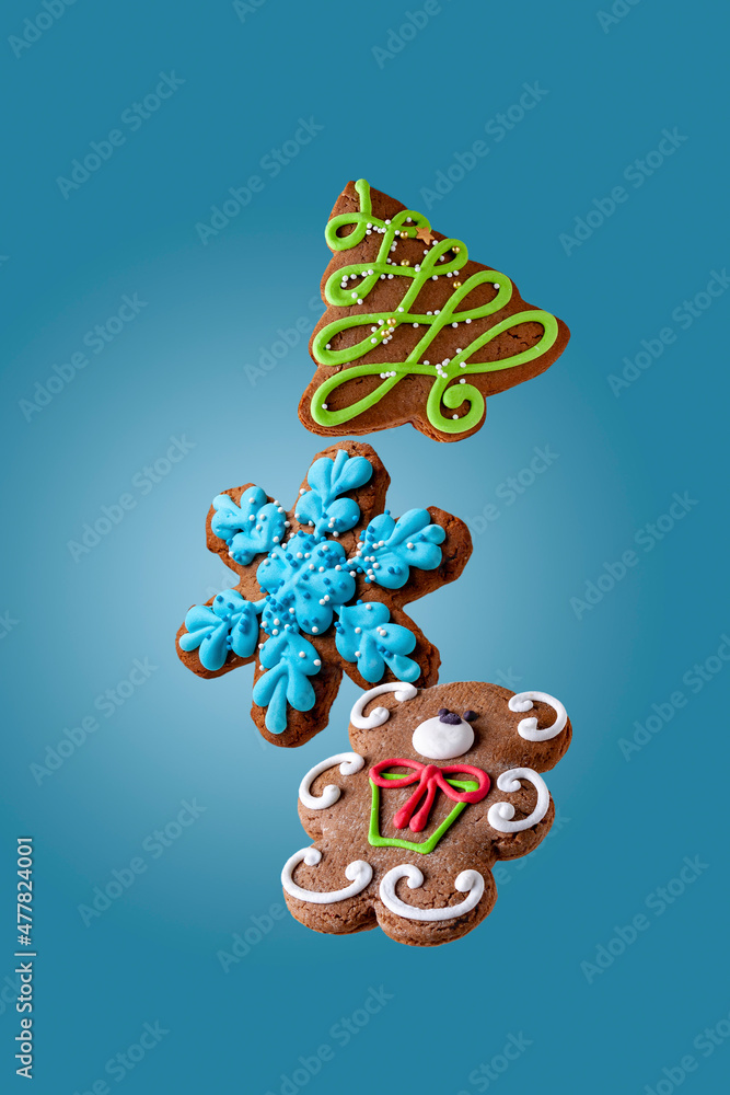 colored gingerbread cookies fly on a blue background colored gingerbread cookies fly on a blue background