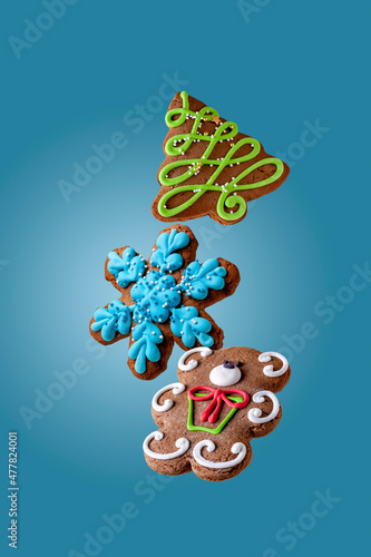 colored gingerbread cookies fly on a blue background