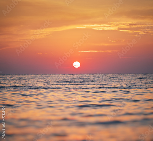 Sun and sea sunset surface background.