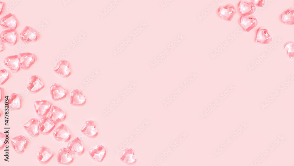 St Valentines day pink background border. Many glass hearts flat lay. Love or wedding concept