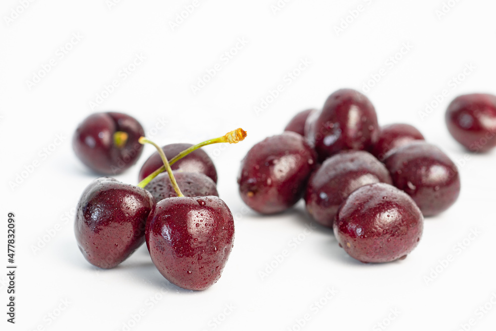 red cherry berries with water droplets isolated on white background red cherry berries with water droplets isolated on white background