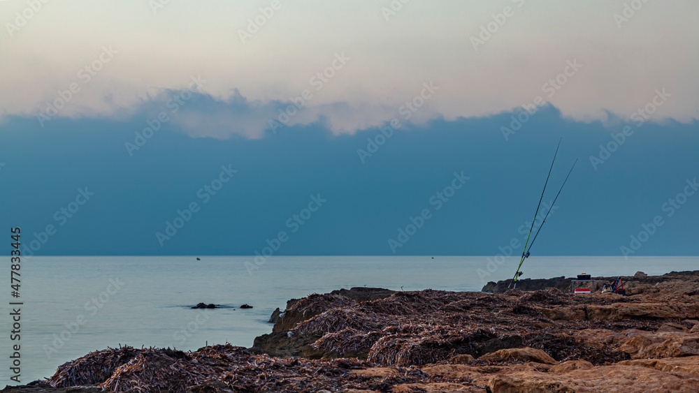Two fishing rods by the sea