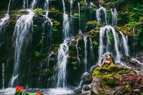 Cascade waterfall with young woman tropical jungle at Bali.