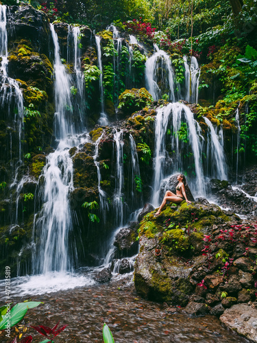 Cascade waterfall with young woman tropical jungle at Bali.