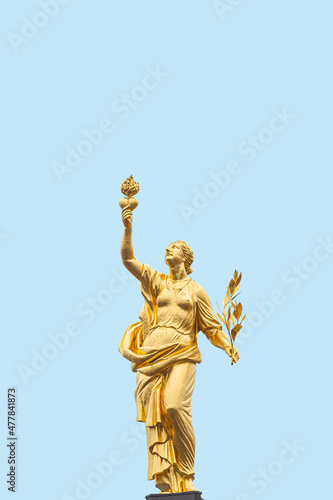 Cover page with a golden statue of Greek goddess of peace Eirene  Pax  with heart and laurel branch in her hands  symbols of love and peace  at blue sky solid background with copy space.