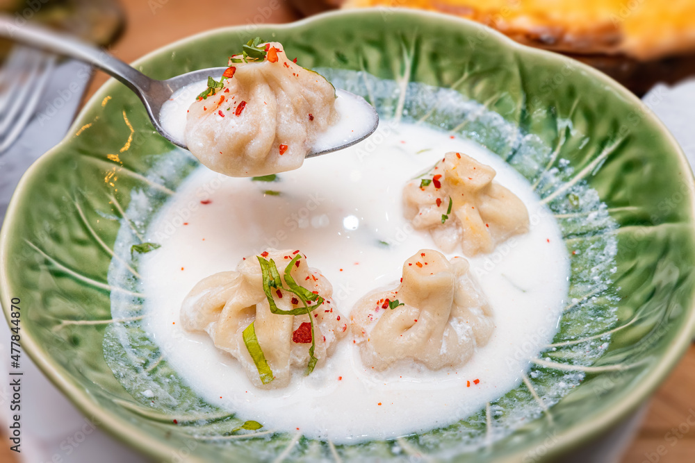 A traditional dish of Georgian cuisine is khinkali with broth in matsoni sauce A traditional dish of Georgian cuisine is khinkali with broth in matsoni sauce
