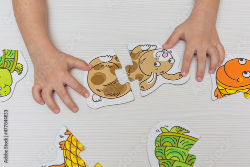 Wallpaper Mural The hands of a child playing with puzzles. Early education, development. Torontodigital.ca