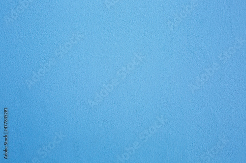 A concrete wall painted blue. Background, texture.